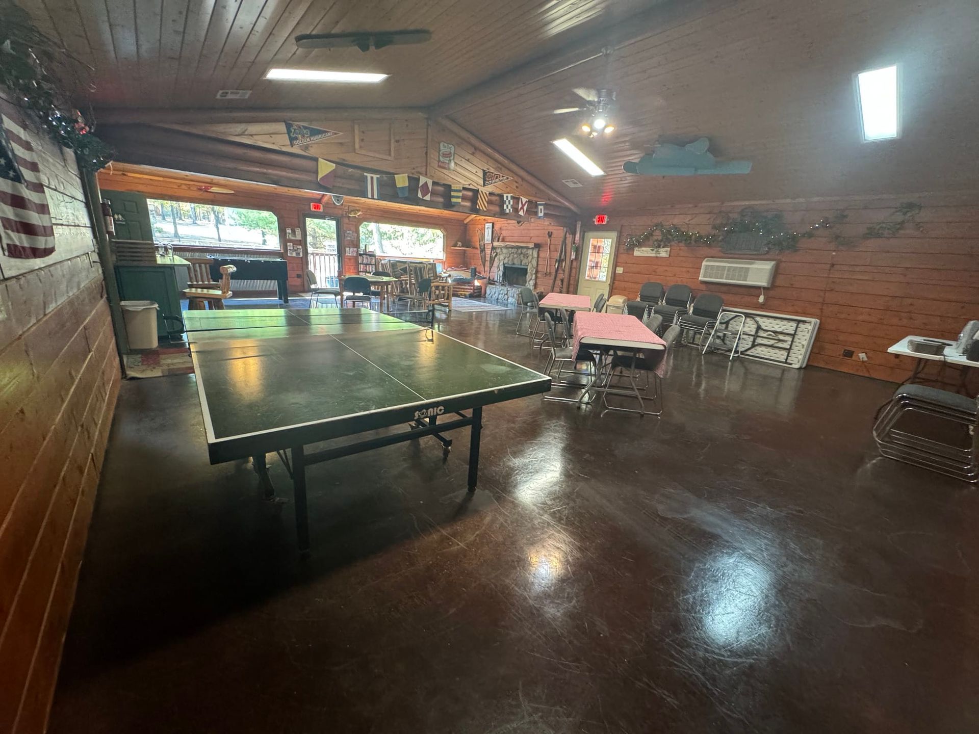 There is a ping pong table in the middle of the room.