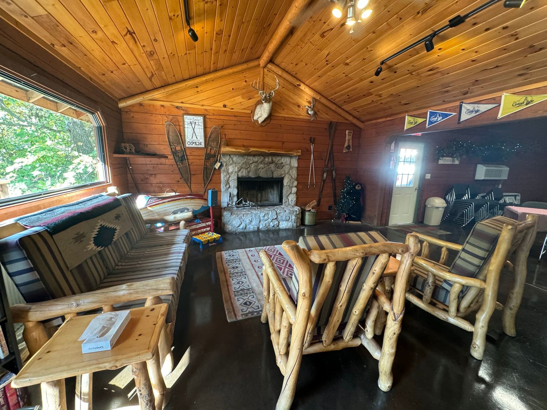 A living room with wooden furniture and a fireplace.