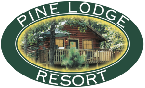 Pine lodge resort logo with a log cabin in the background