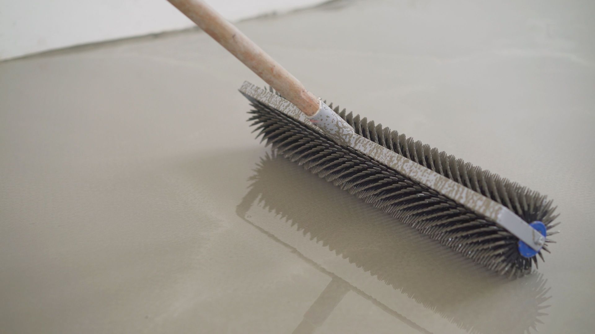 a concrete sidewalk in a residential neighborhood with a lush green lawn .