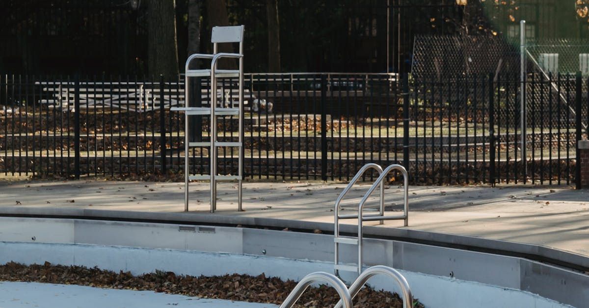 An Empty Swimming Pool With a Lifeguard Chair in the Background — AM & JD Contracting In Muswellbrook, NSW