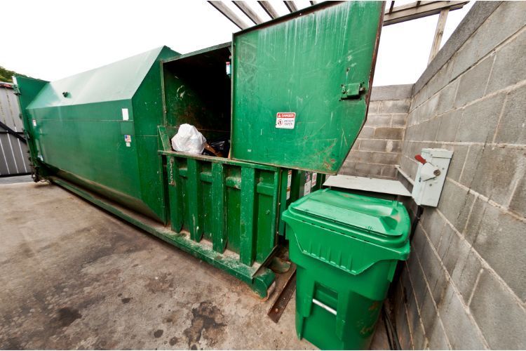 big green trash compactor