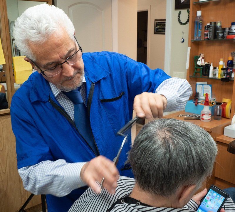 man cutting another man's hair
