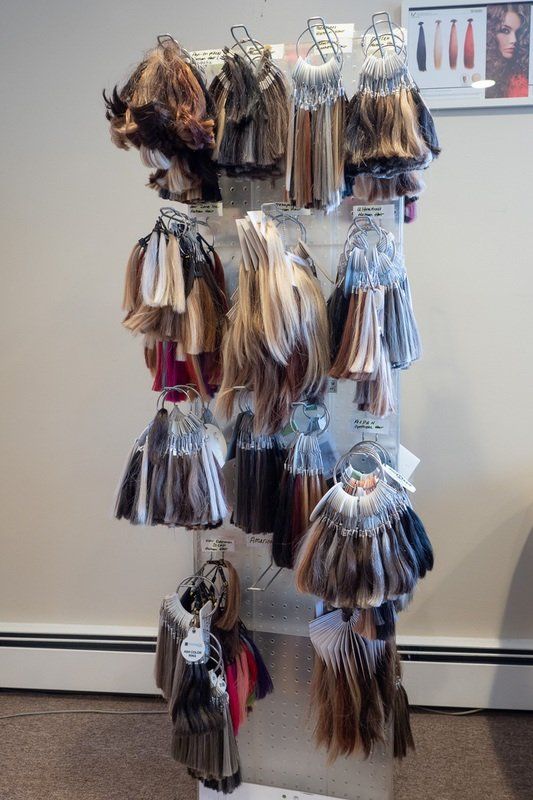 rack of different colored hair extensions