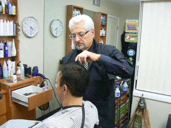Mr. Carmine cutting man's hair