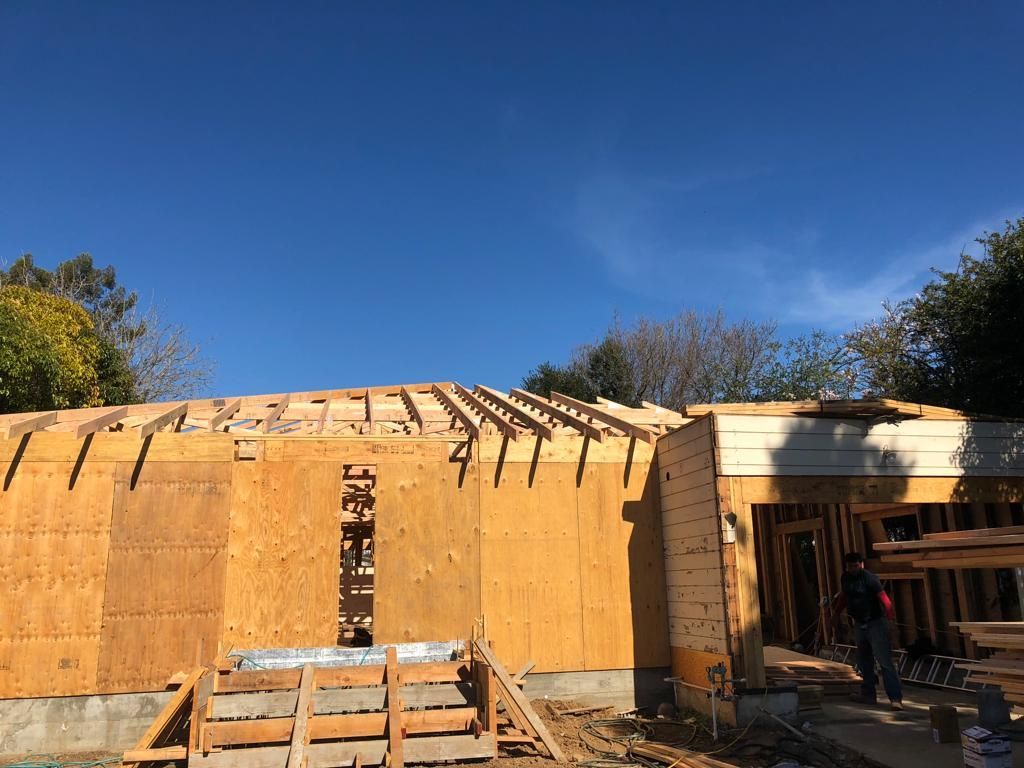 A house is being built with a blue sky in the background.