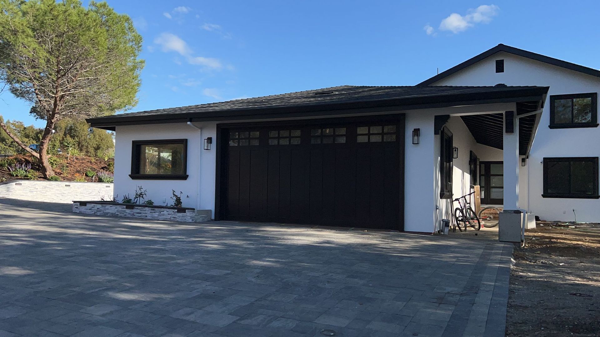 A white house with a black garage door