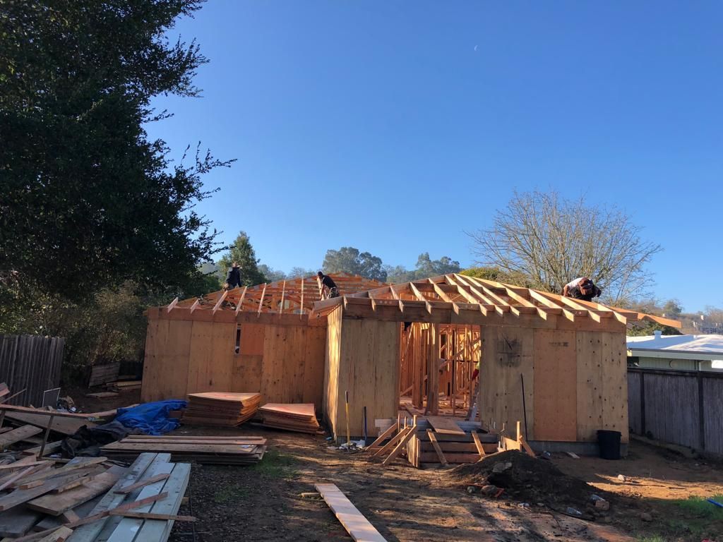 A house is being built with a blue sky in the background.