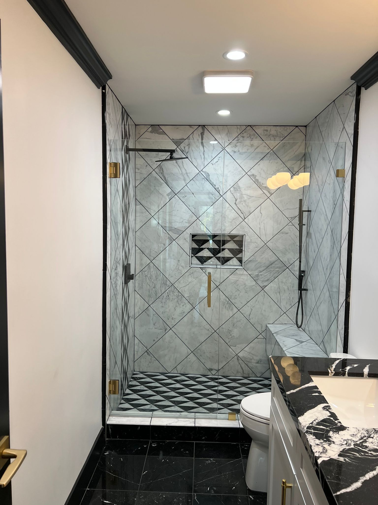 A bathroom with a walk in shower and a toilet.