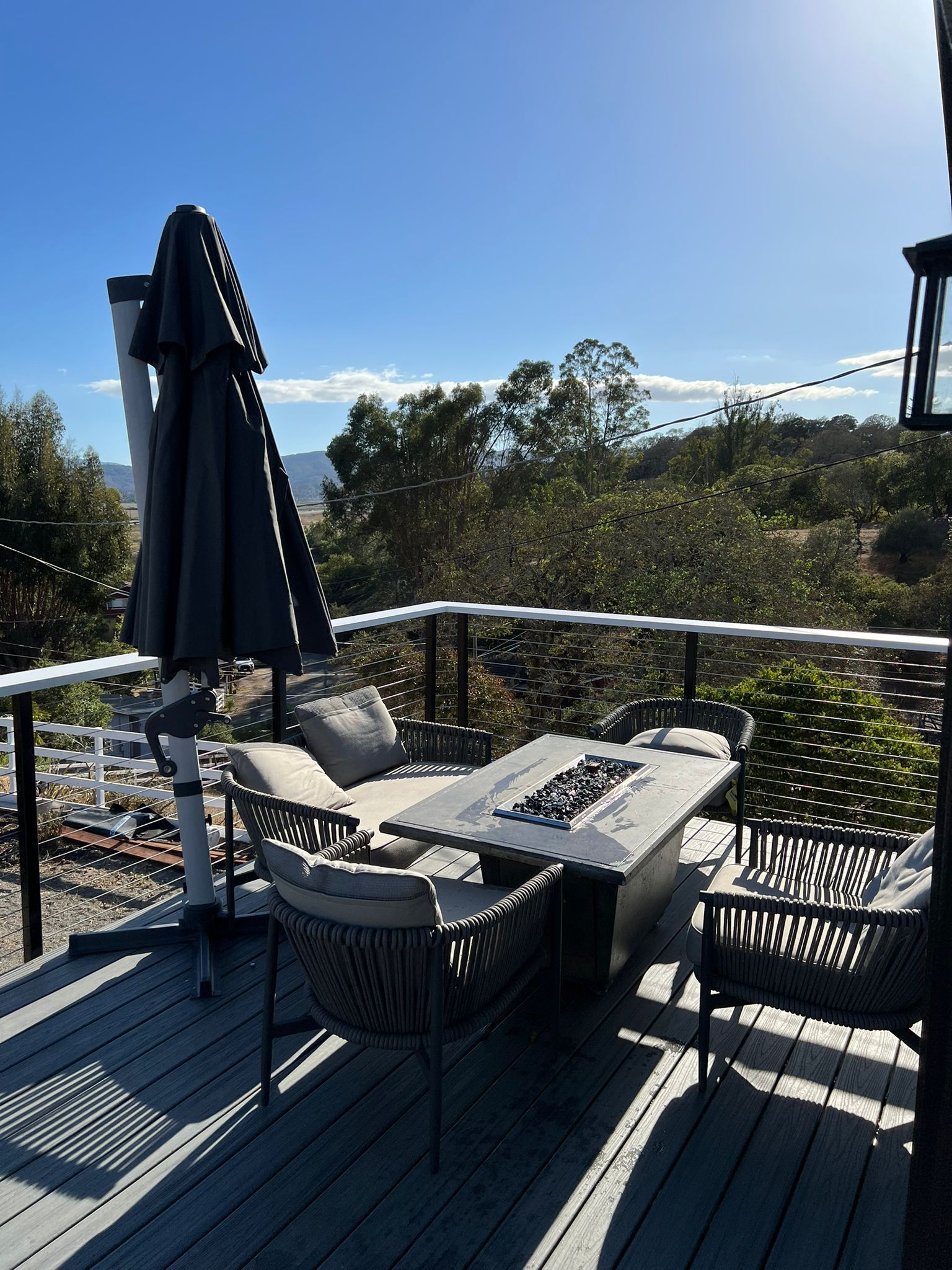 A deck with a table and chairs and an umbrella