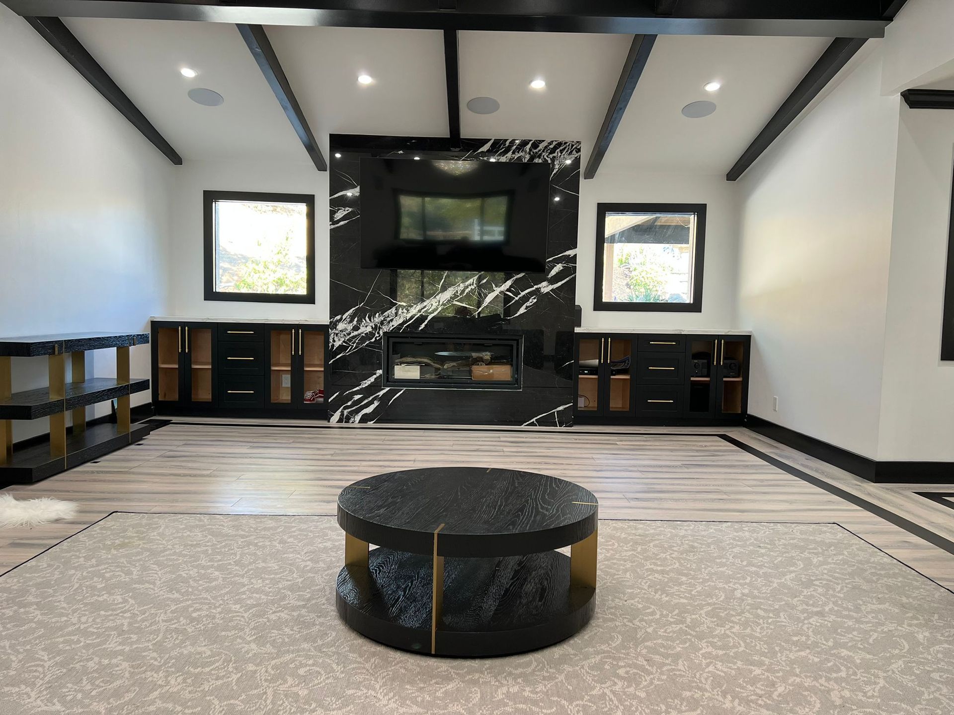 A living room with a round coffee table in the middle