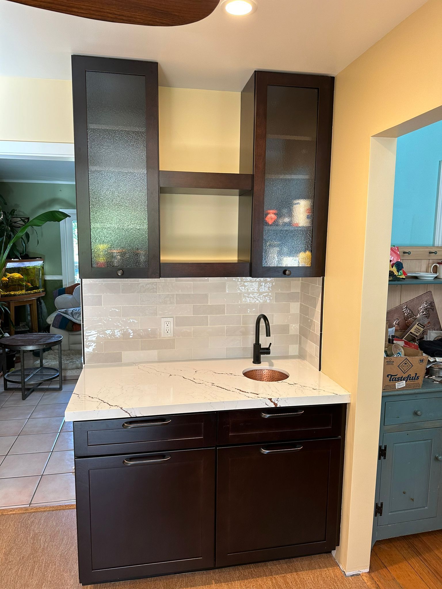 A kitchen with brown cabinets and a sink in it