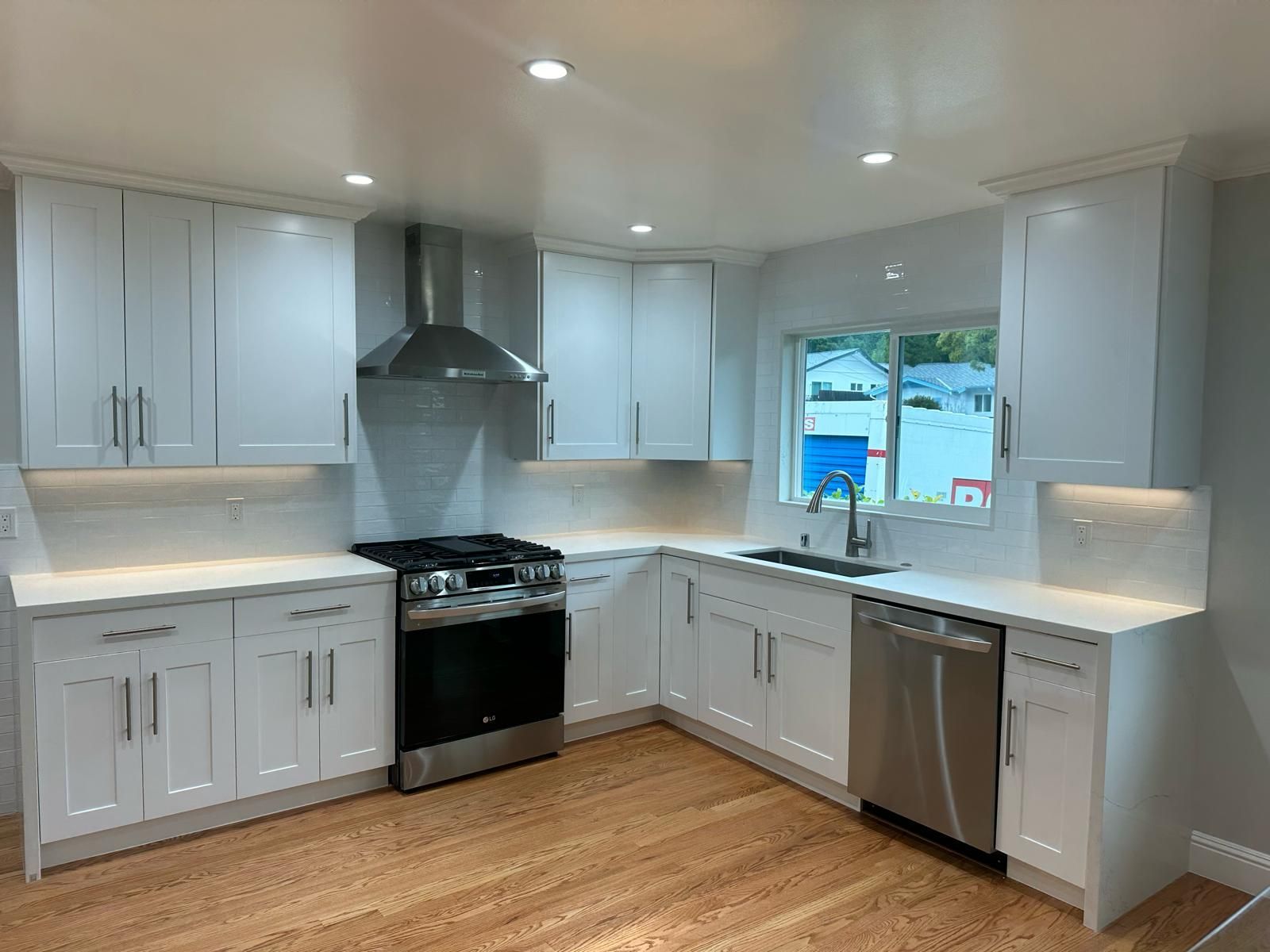 A kitchen with white cabinets and stainless steel appliances.