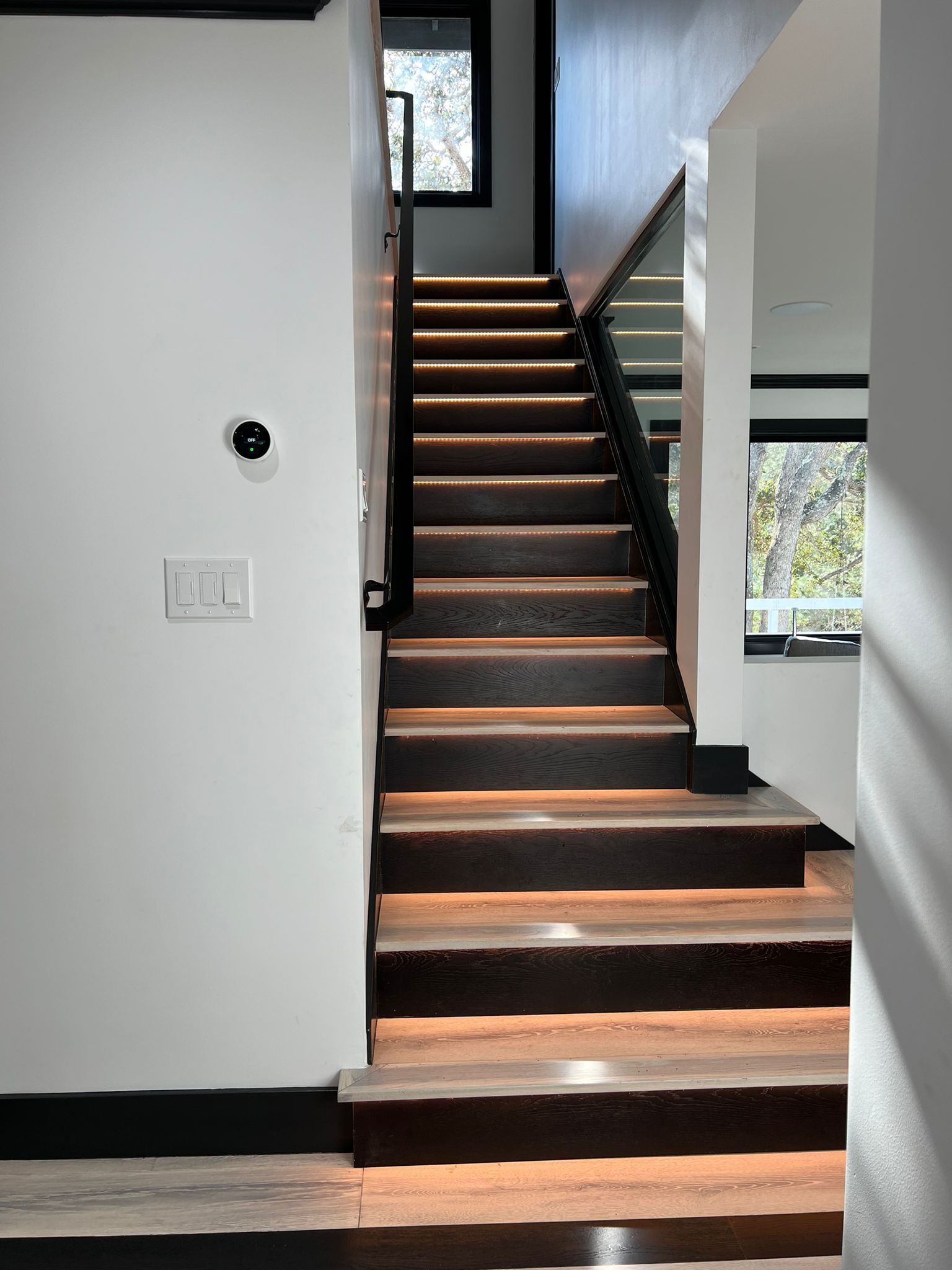 A staircase in a house with lights on the steps
