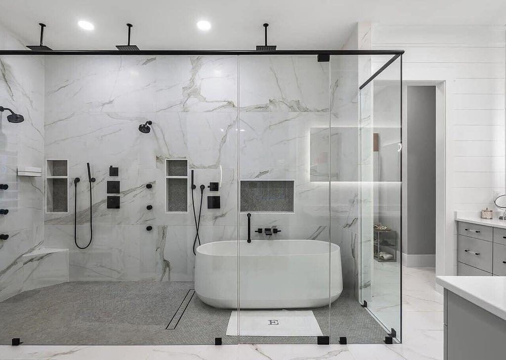 A bathroom with a bathtub and a walk in shower.