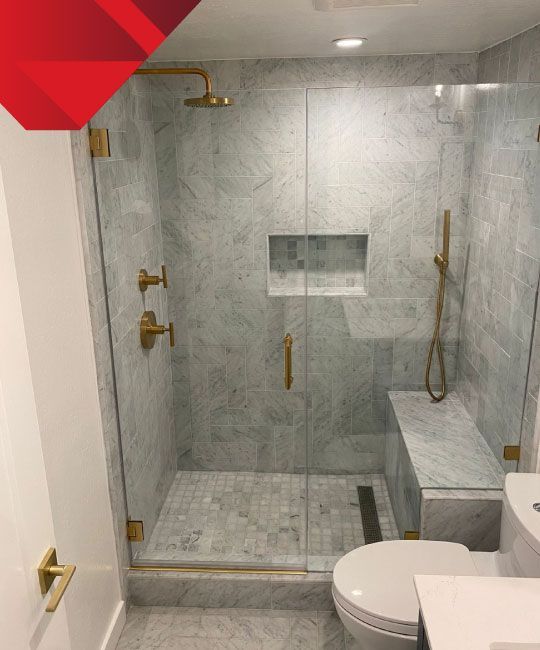 A bathroom with a walk in shower and a toilet