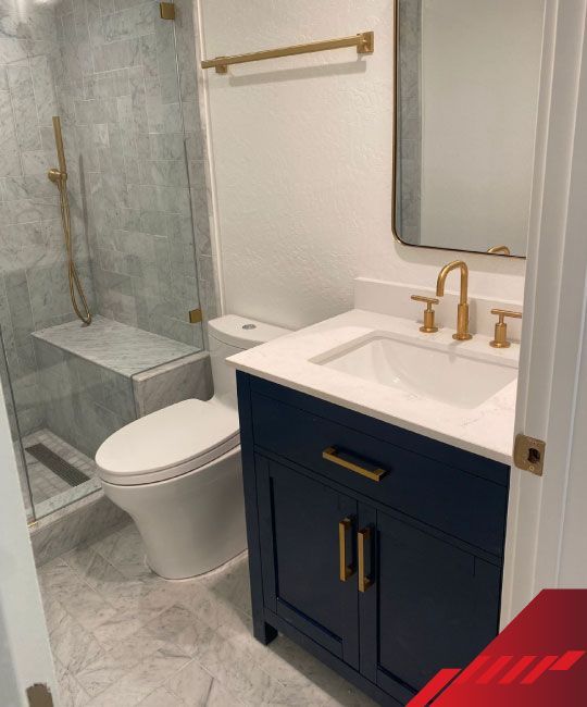 A bathroom with a toilet a sink and a mirror