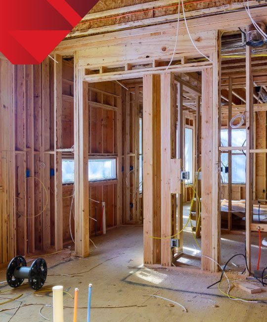 A house is being built with a lot of wood and wires.