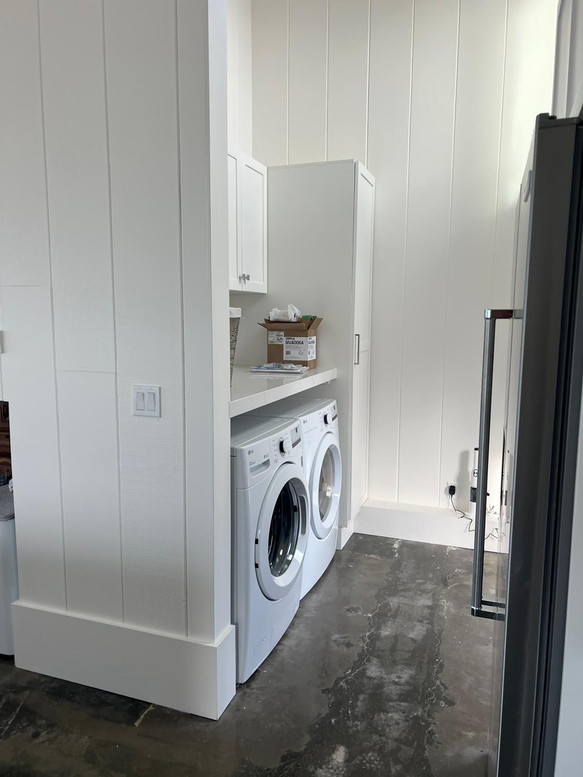 A laundry room with a washer and dryer in it.