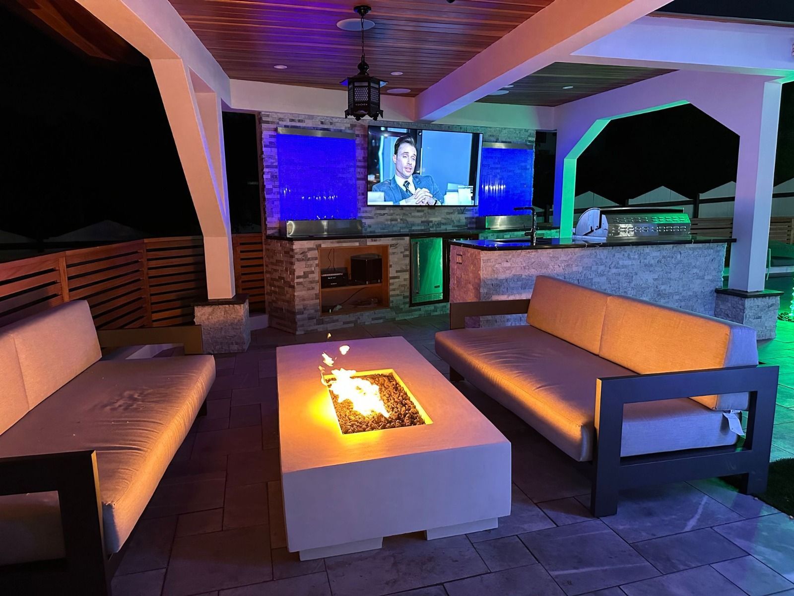 A living room with a fire pit and a television