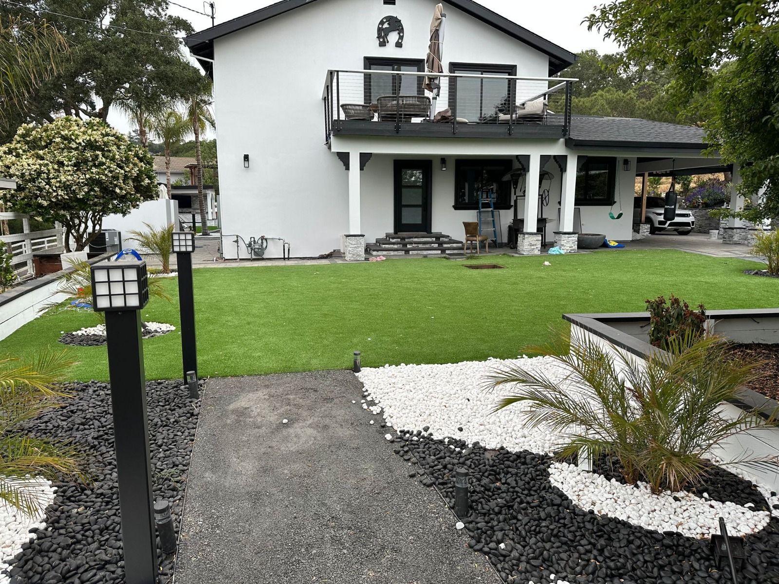 A large white house with a large lawn in front of it
