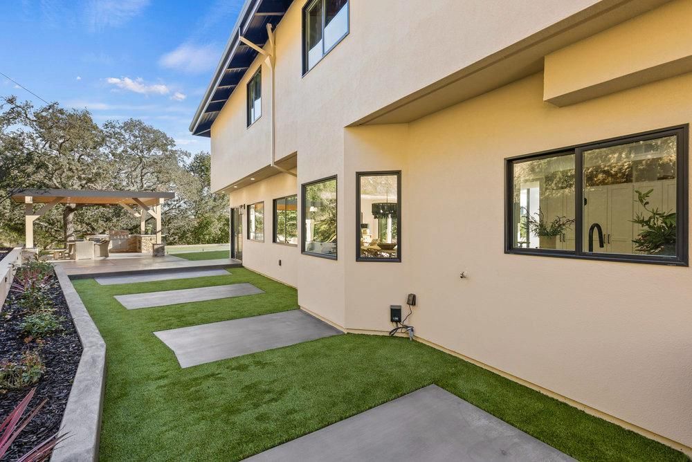 A large house with a lot of windows and a lawn in front of it.