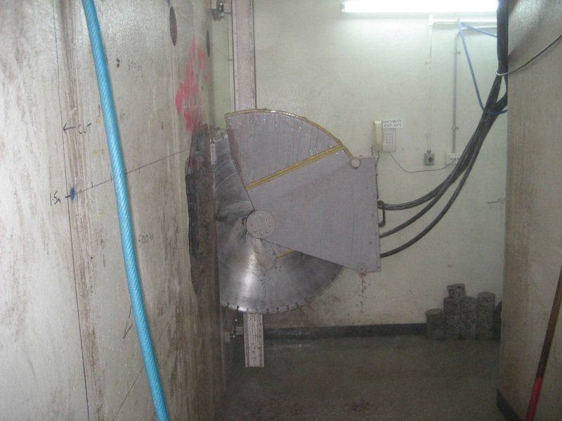 Cutter being used to cut a hole in a wall