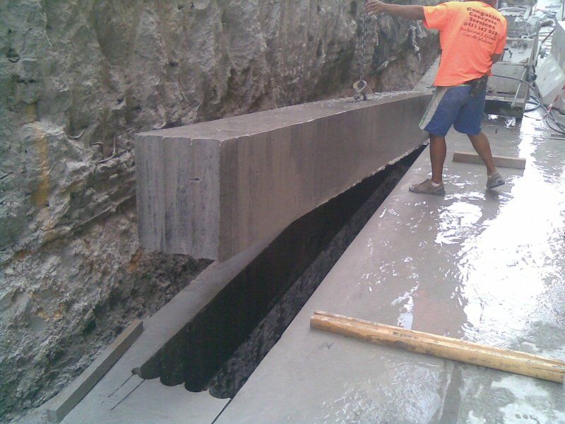 Big concrete support structure being lifted with the help of crane