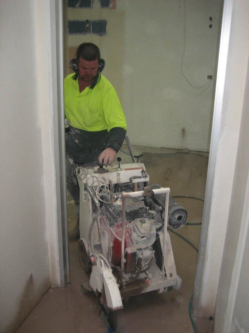 contractor taking the machine out of the room