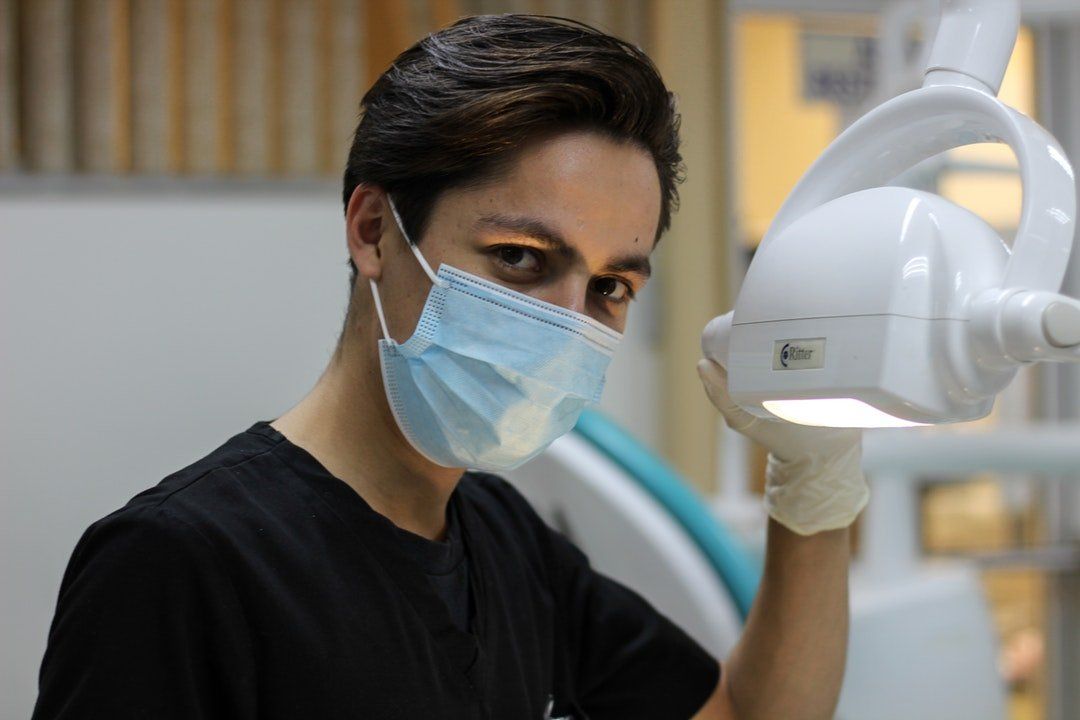 male cosmetic dentist looking at viewer