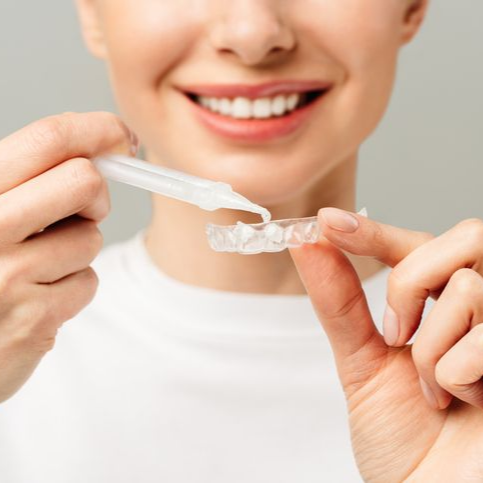 A woman is getting her teeth examined by a dentist.