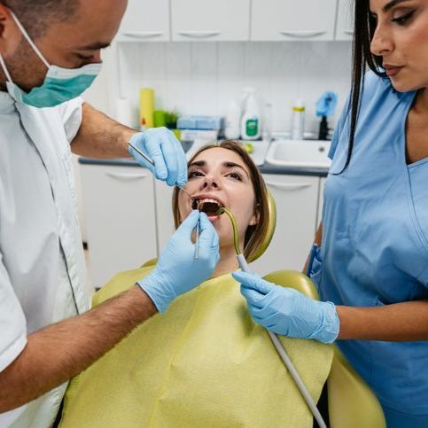 A dental chair with a monitor attached to it