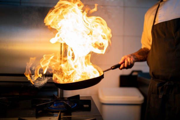 Chef Preparing Flame Meal Using Pan — Montrose, CO — Frontline Fire Defense