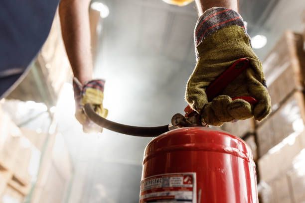 Man Using Fire Extinguisher — Montrose, CO — Frontline Fire Defense