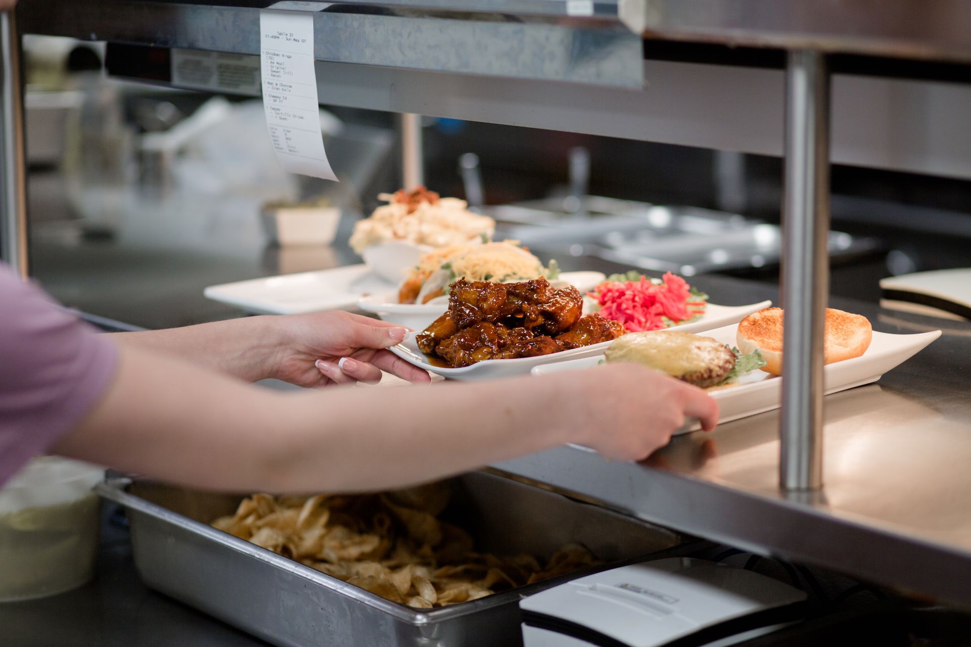 person grabbing food from the kitchen