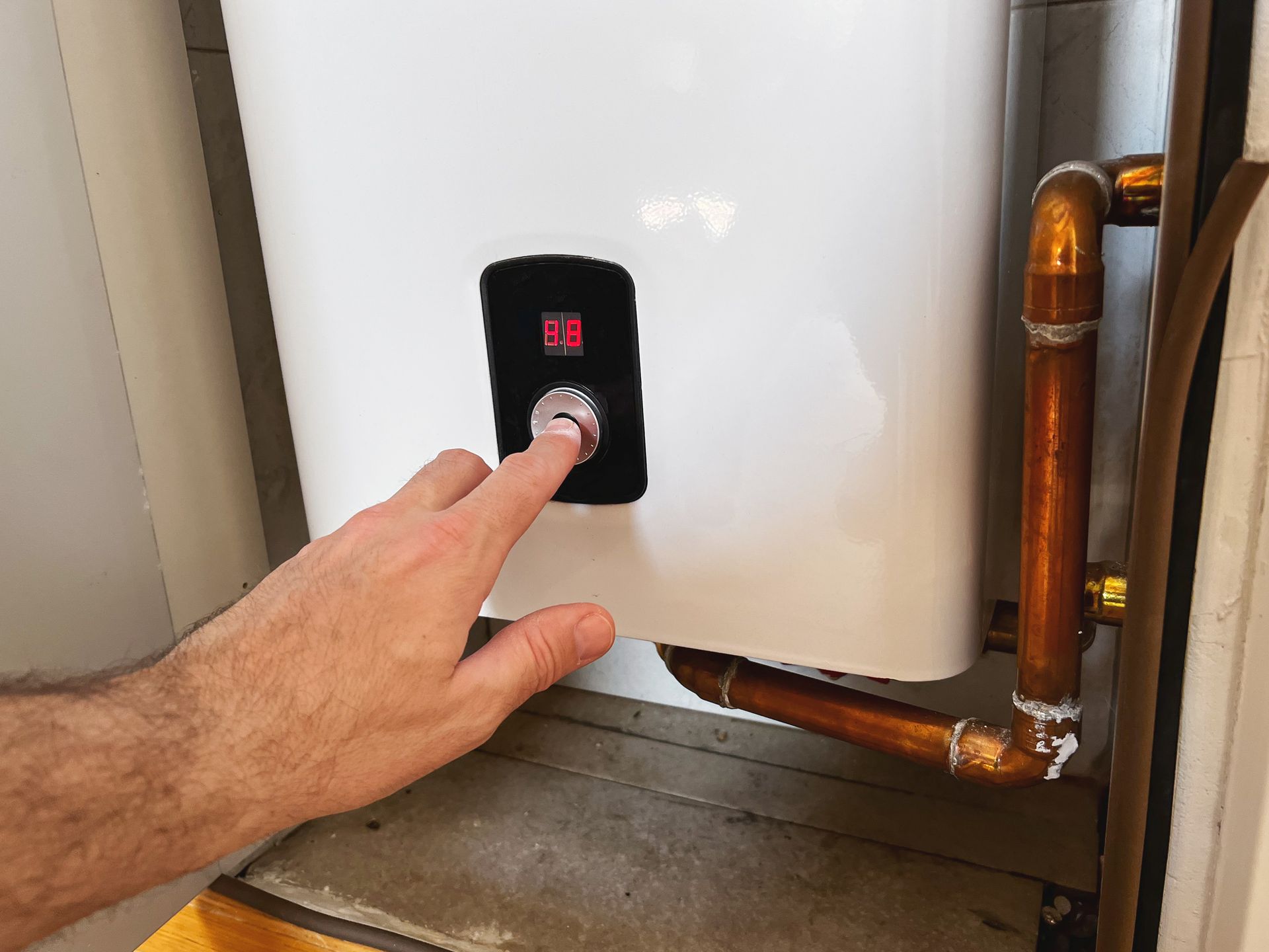 Setting electric boiler for home underfloor heating system.