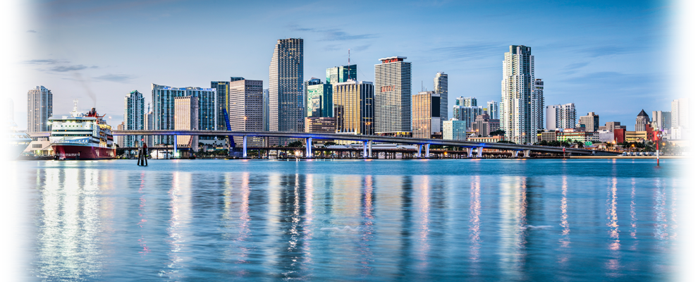 The skyline of a city is reflected in the water.