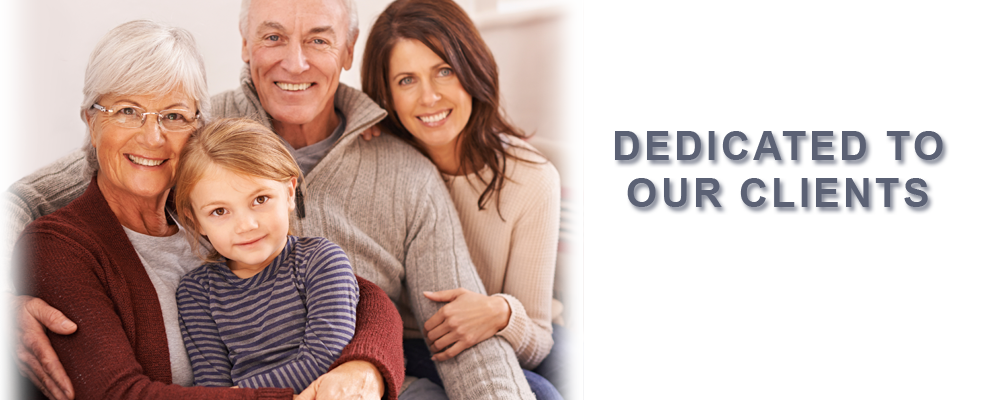 A family is posing for a picture while sitting on a couch.