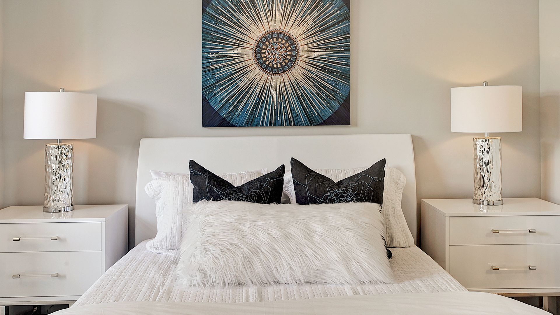 An empty room with hardwood floors and three windows.