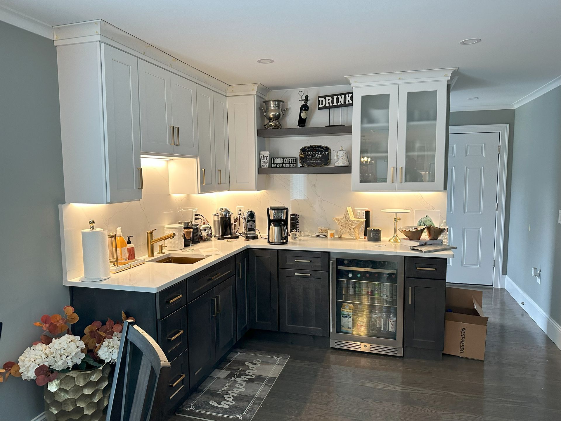 A kitchen with a refrigerator , sink , and cabinets.