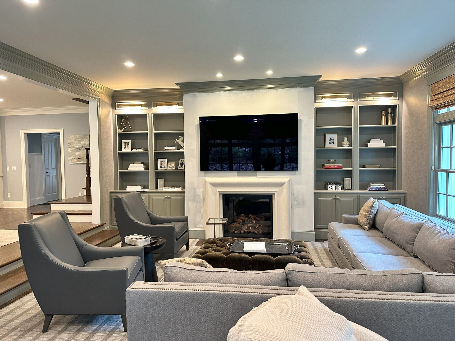 A living room with a couch , chairs , and a fireplace.