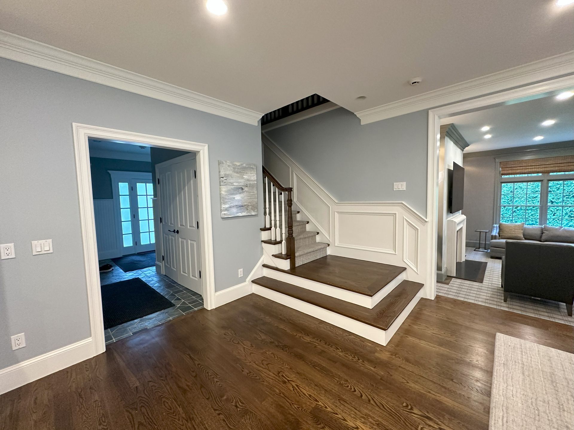 A hallway with stairs leading up to the second floor of a house.