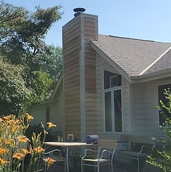 A house with a large chimney on top of it