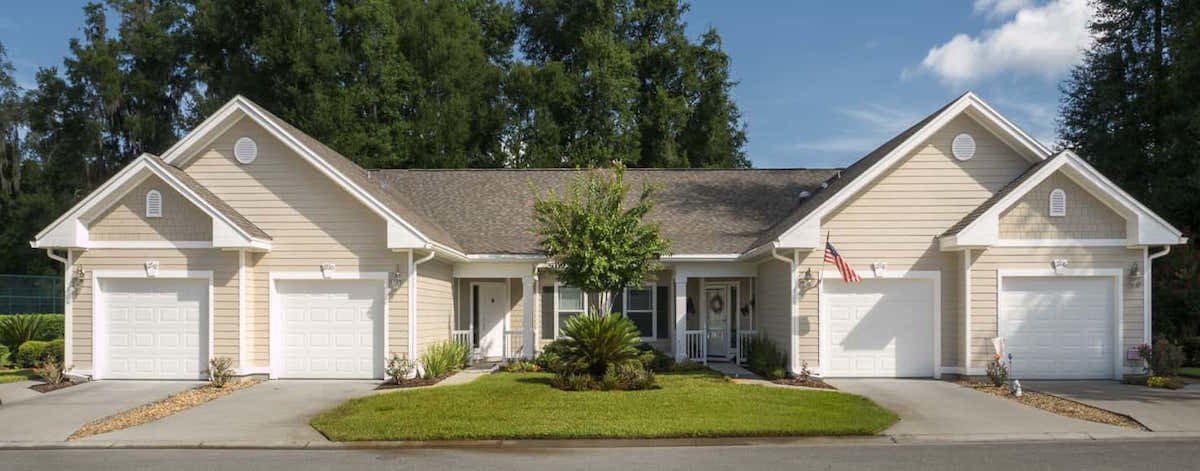 Beige, single-story duplex with white trim