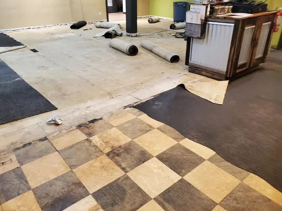 A room with a checkered floor and a counter.