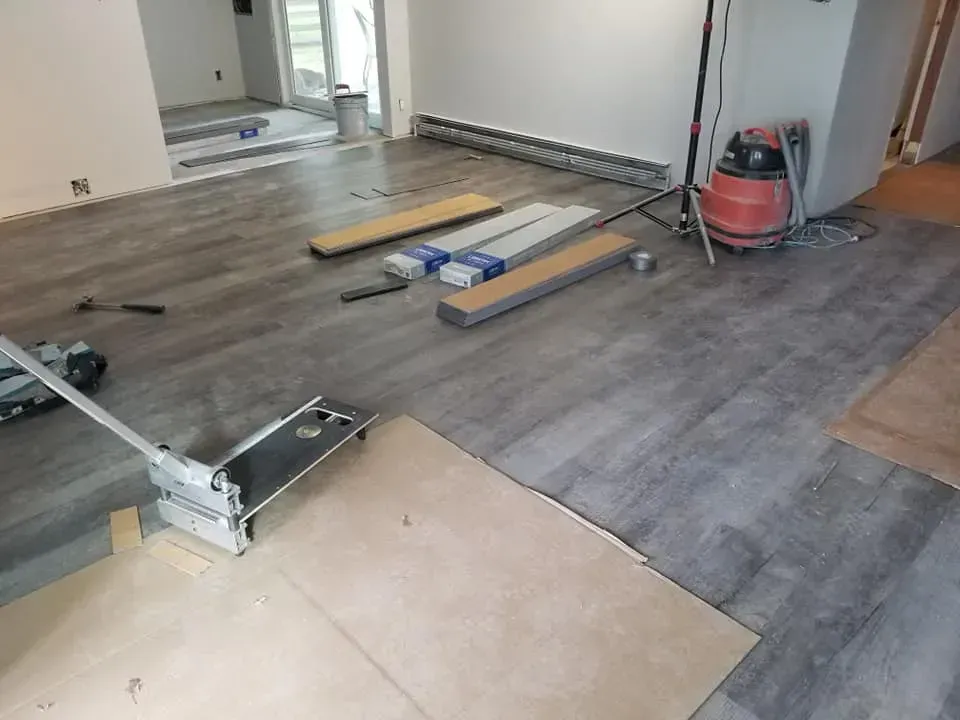 A room with a wooden floor and a vacuum cleaner on the floor.