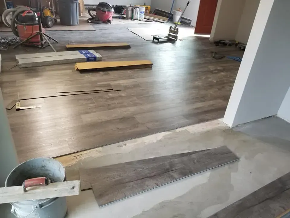 A wooden floor is being installed in a room.