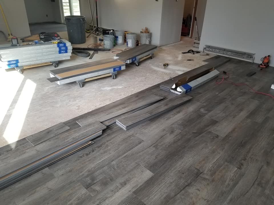 A wooden floor is being installed in a room.
