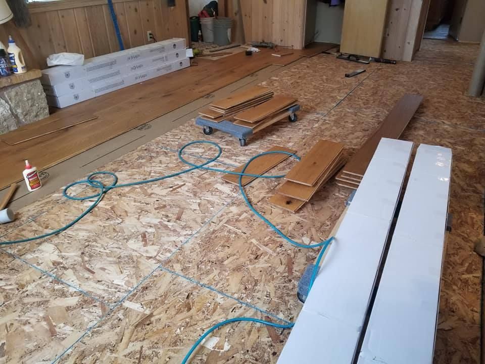 A room with wooden floors and a hose on the floor.