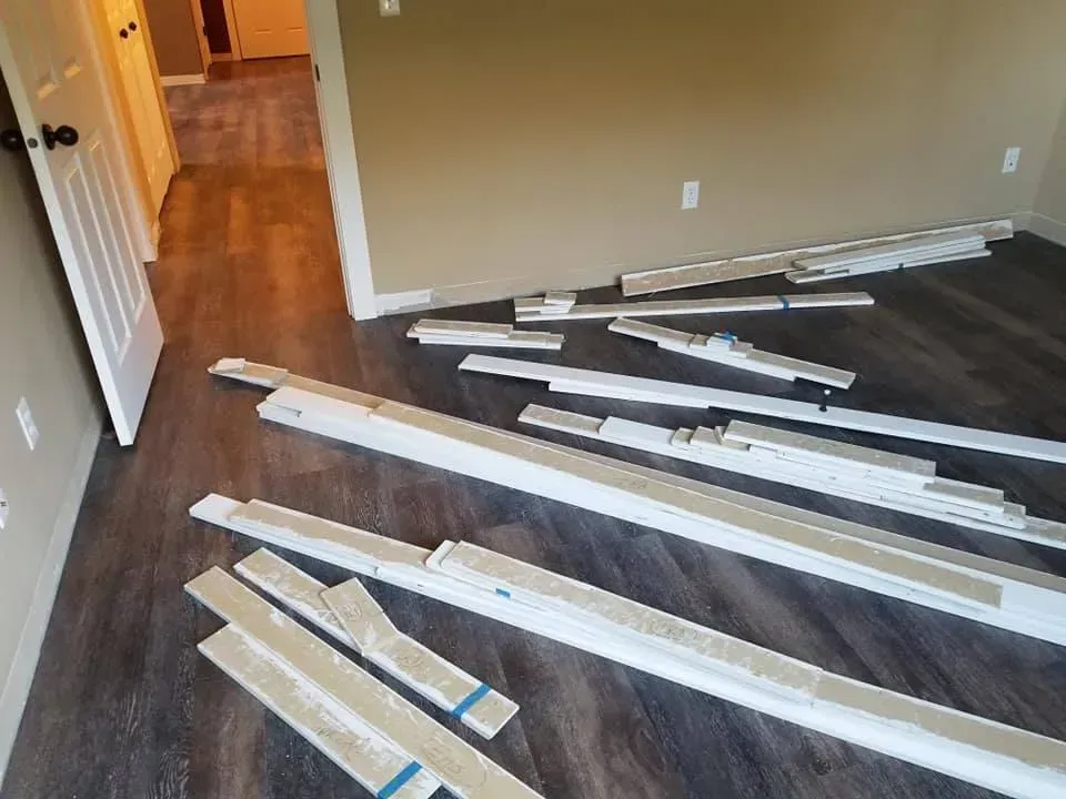A bunch of wooden boards are laying on the floor in a room.